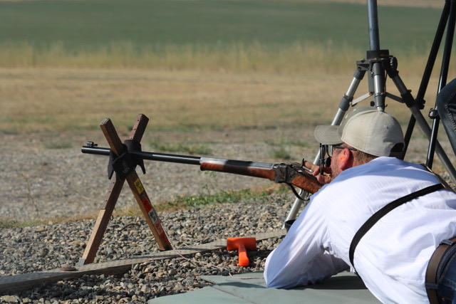 Prone long-range iron-sight match, shooting off cross-sticks.